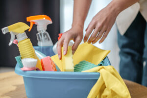 Cleaning. Close up picture of hands taling something from the box with cleaning supplies